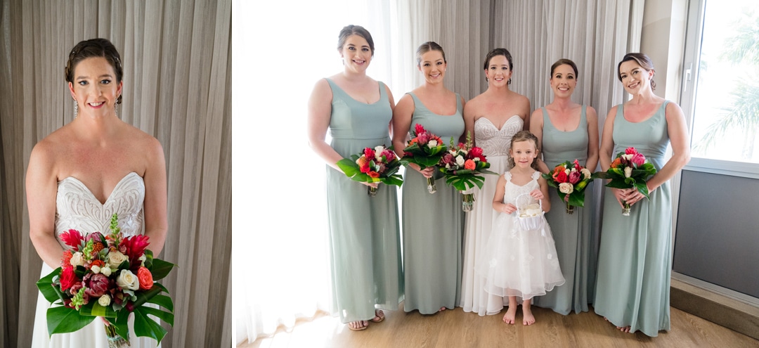 A bride stands with her bridesmaids as they wear light blue-green dresses.