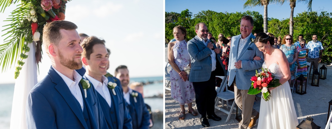 A groom watches his bride and her father walk down the aisle on a beach in Aruba.