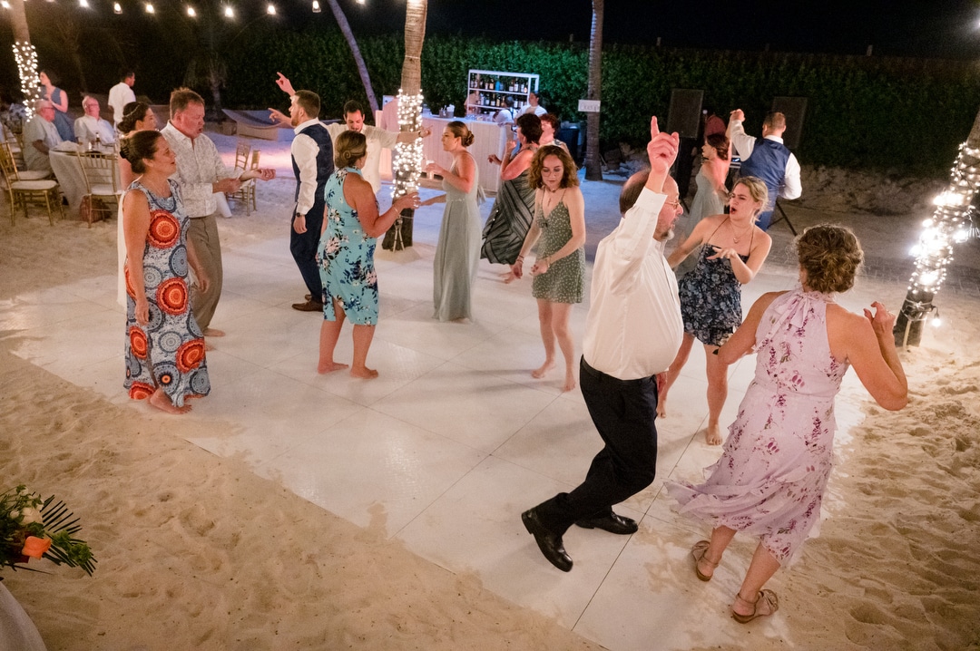 Guests fill the dance floor at a destination wedding in Aruba.