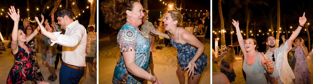 Guests dance on a beach during a destination wedding in Aruba.