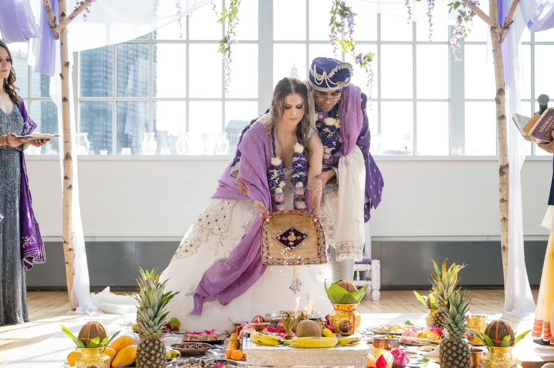 A couple during their South Asian wedding ceremony at the Energy Innovation Center.
