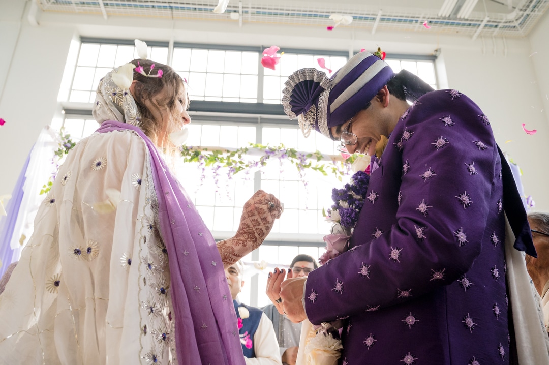 A couple is pelted with flower petals during their Energy Innovation Center wedding.