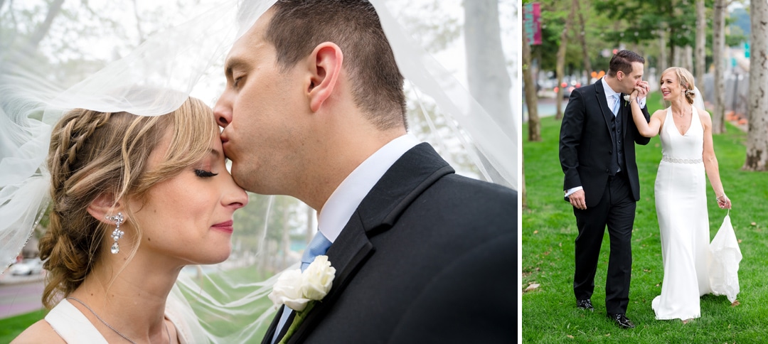 A groom kisses his bride on the forehead as they stand beneath her veil in the park outside of the Pittsburgh Renaissance hotel. In another photo a bride and groom walk together through the park after their wedding. The groom kisses his bride's hand as she looks at him and smiles.