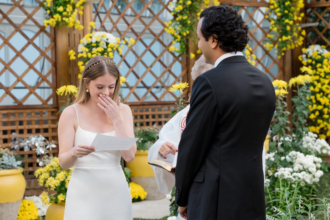 A bride holds back tears as she reads her vows during an intimate wedding at Phipps.