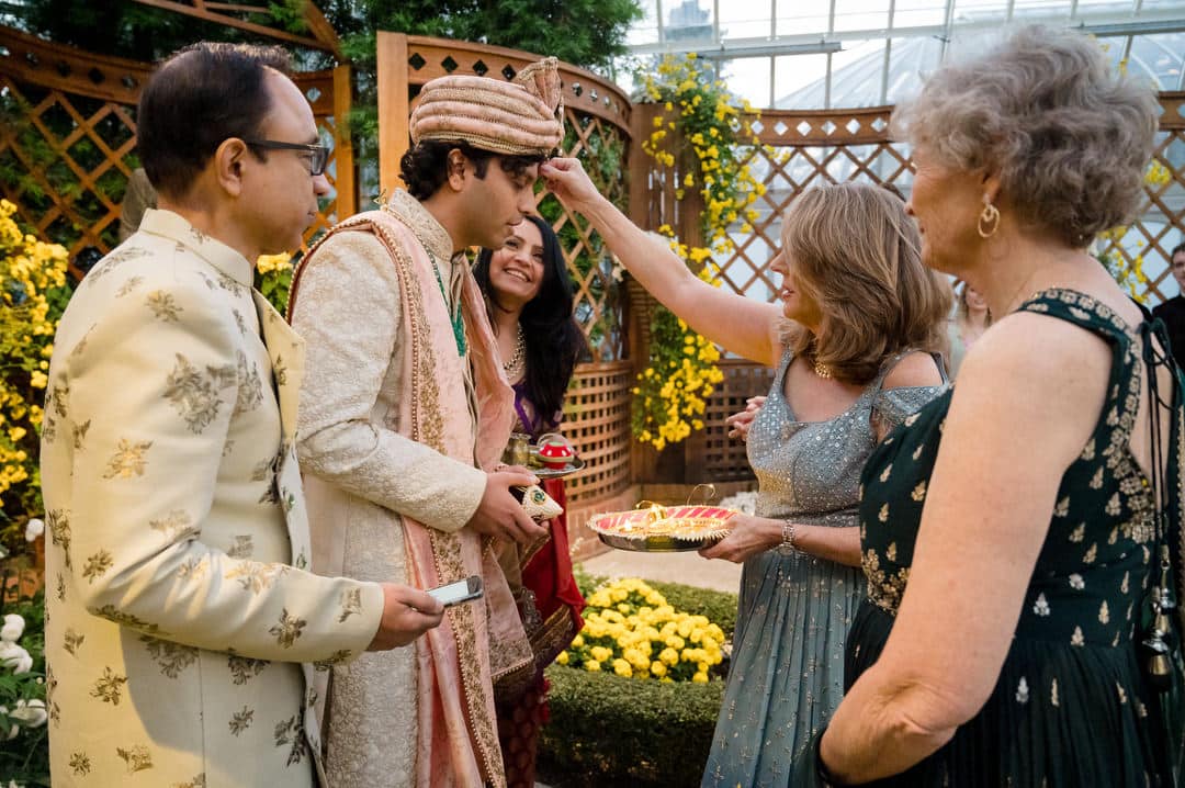 A groom is blessed by his mother in law during an intimate south asian wedding ceremony at Phipps.