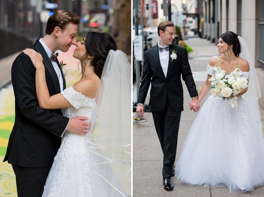 A bride and groom walk and embrace on the street in downtown Pittsburgh near the Hotel Monaco.