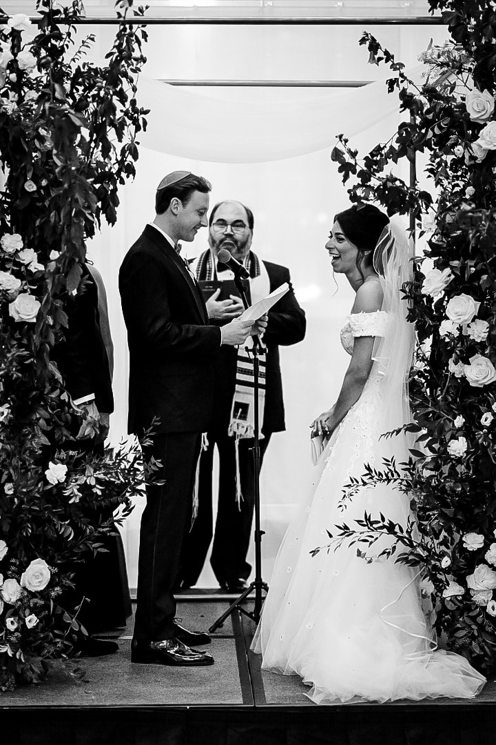 A bride and groom exchange vows before a rabbi during their wedding at the Hotel Monaco in Pittsburgh.