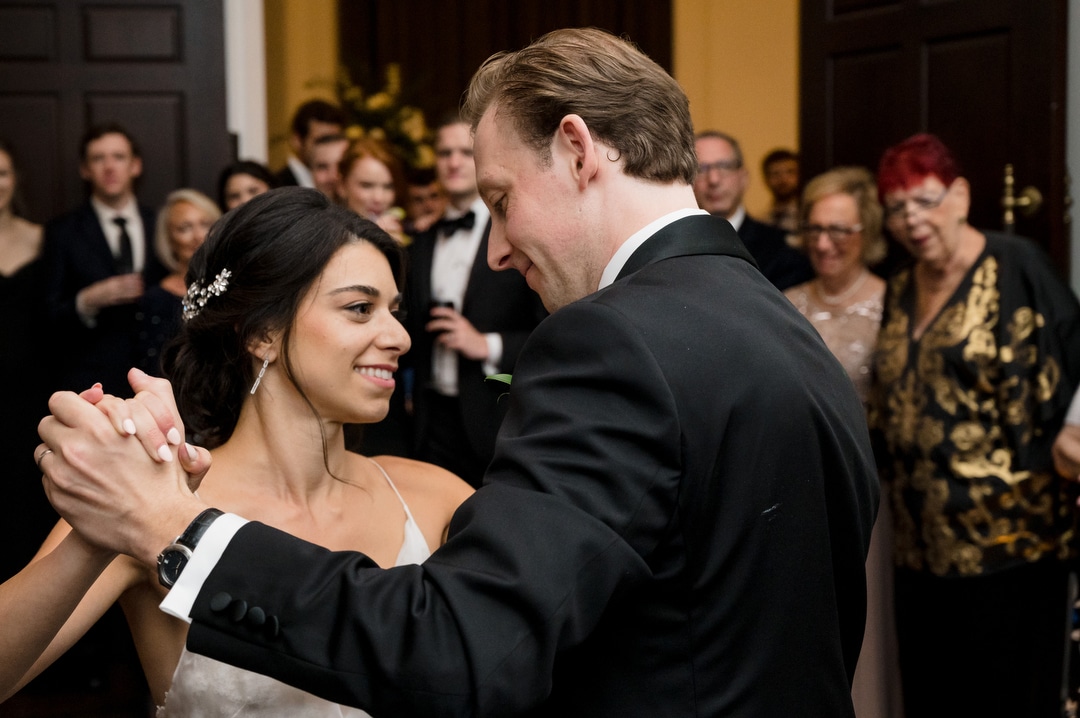 A bride and groom smile as they share their first dance at the Hotel Monaco in Pittsburgh.