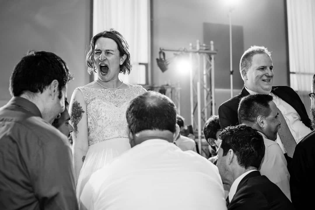 A couple reacts as they are raised on chairs at their Saint Nicholas Cathedral Room wedding in Pittsburgh.