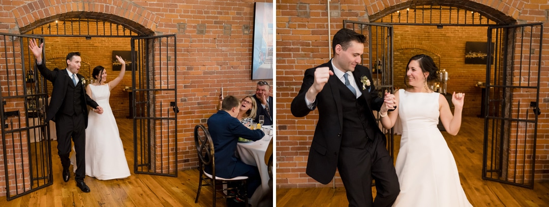 A couple joyfully enters The Art Room Wedding through open metal gates, the brick walls echoing their laughter. They dance and celebrate, smiling happily, as guests in formal attire enjoy the vibrant atmosphere from their tables.