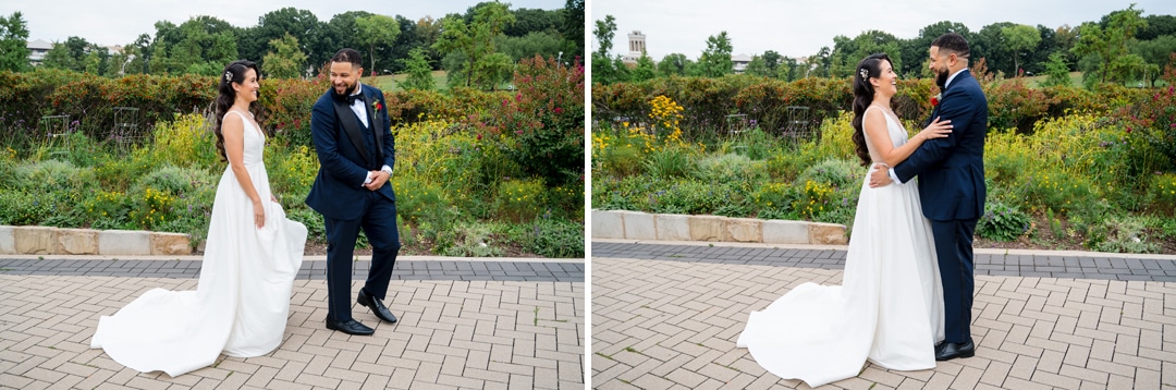 Two wedding photos of a bride in a white gown and a groom in a navy suit. In the first, the groom admires the bride; in the second, they smile and embrace outdoors on a path with greenery and flowers in the background.